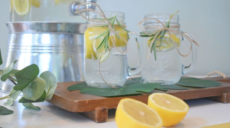 lemon with lemon water in glass jars